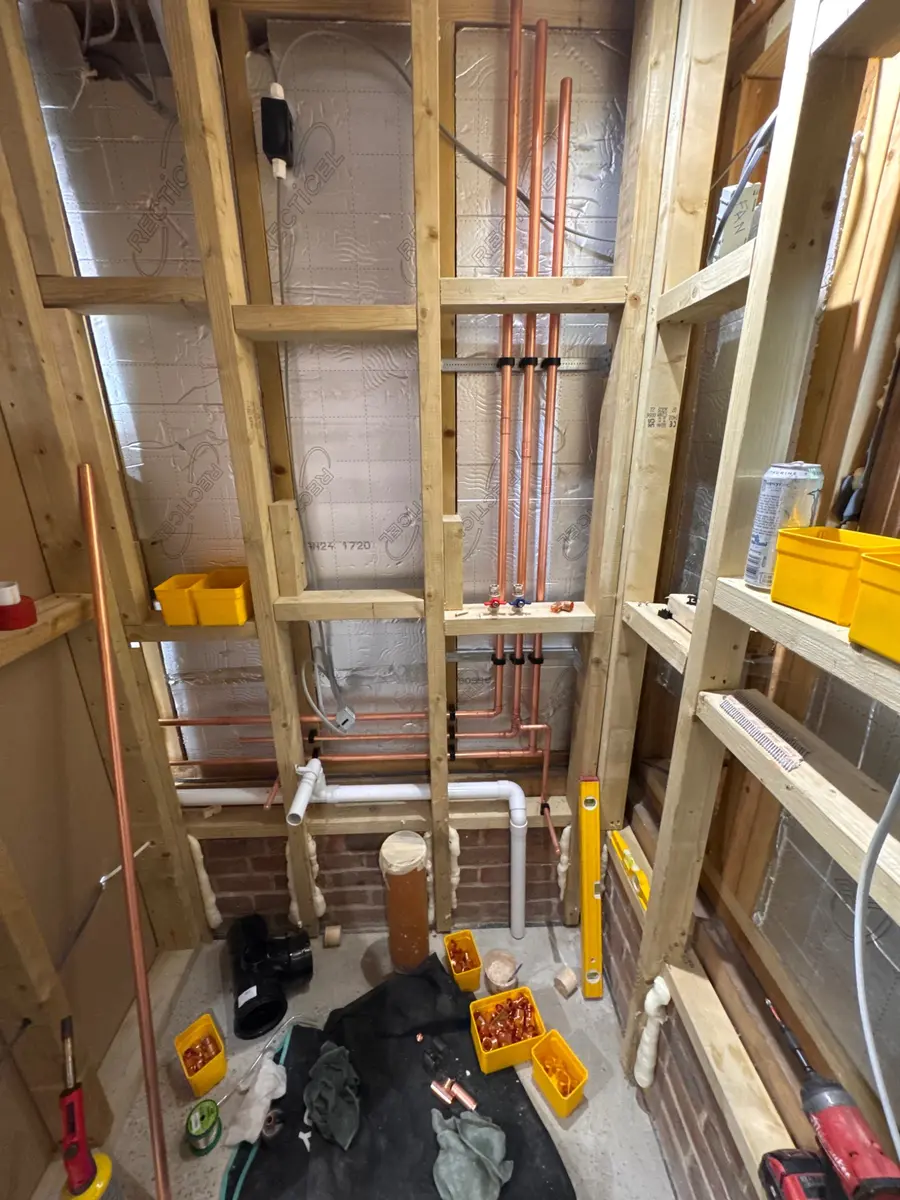 Neat copper first-fix pipework within timber framing